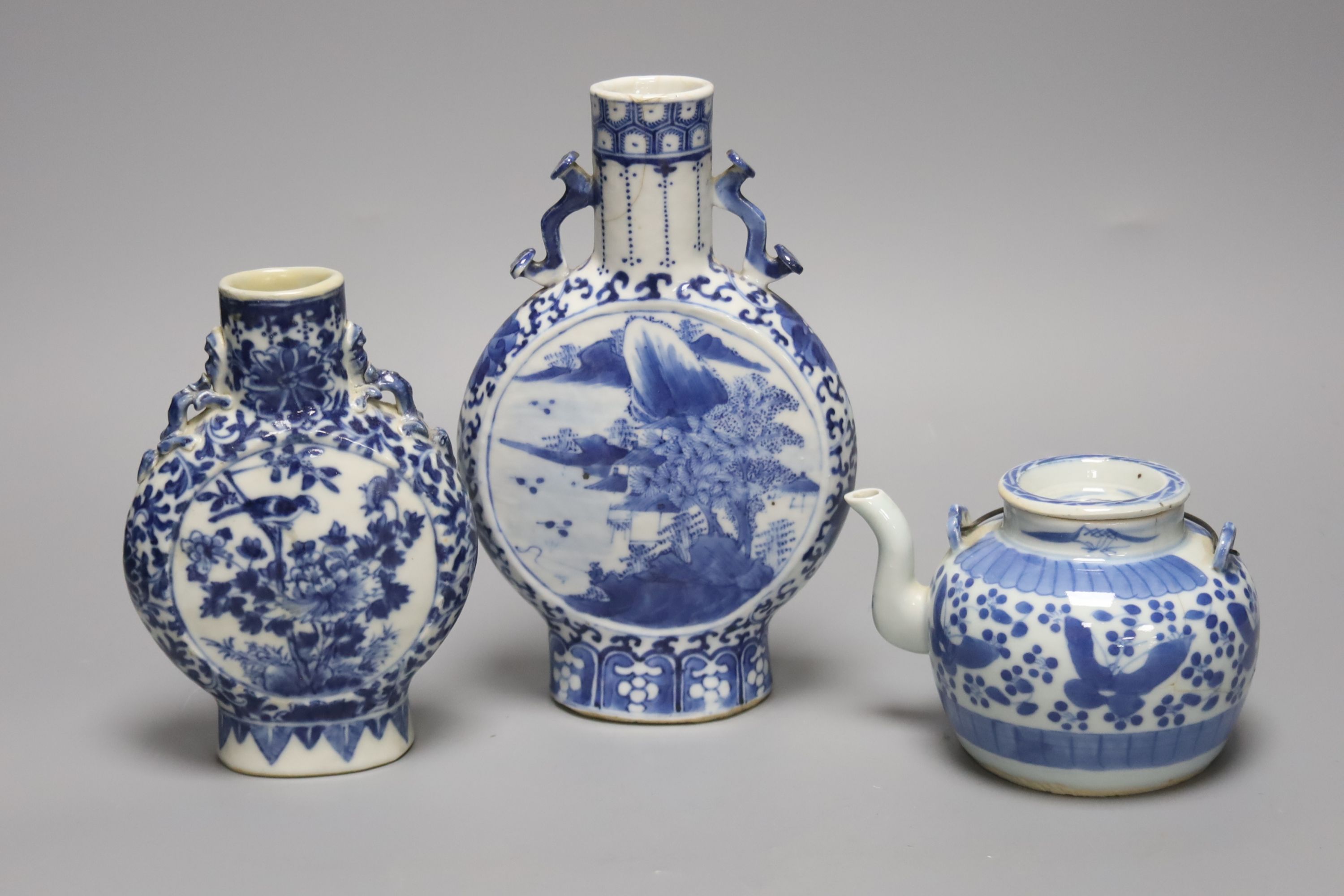 Two 19th century Chinese blue and white moon flasks and a teapot, tallest 21cm